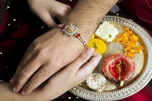 Sister Tying Rakhi to Brother's Hand